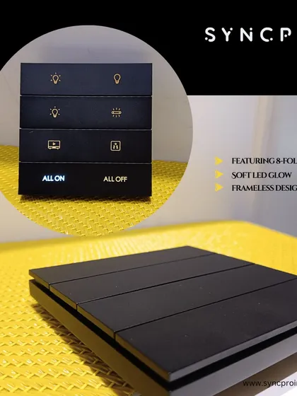 This is our in-house designed SyncPro smart keypad, featuring a sleek, frameless black design. The keypad offers 8-fold functionality with clear, icon-based buttons and an 'All On/All Off' feature, all enhanced by a soft LED glow for easy use in any lighting condition.