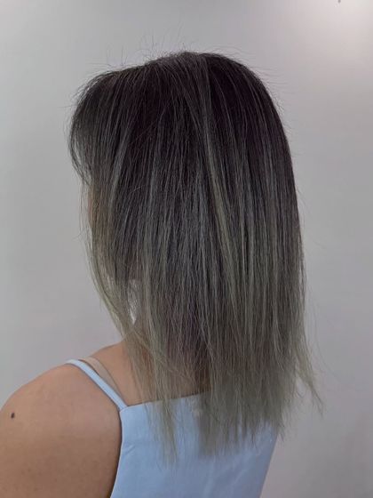 A short hair transformation. We went for a modern, textured cut with an ash ombre color, creating a look that is both edgy and chic.