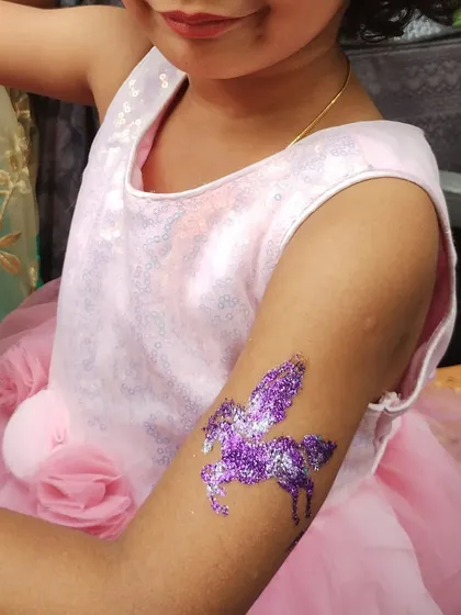 Dressed like a princess and with a sparkling purple pegasus tattoo to match. I love helping kids complete their party look with a special piece of glitter art.