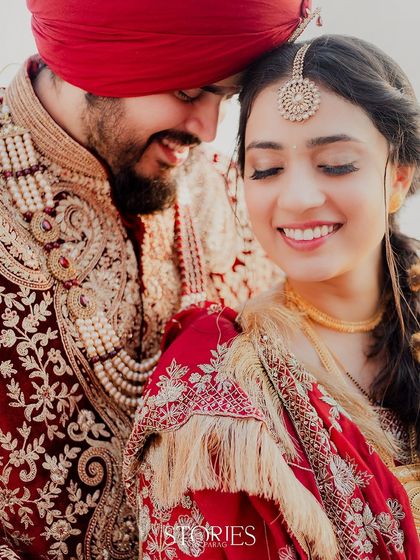 The golden hour light adds a magical glow to this intimate portrait. The couple shares a quiet, happy moment, their smiles reflecting the warmth and beauty of their wedding day.