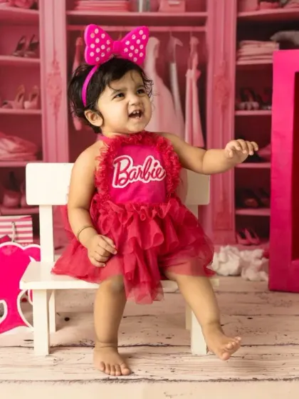 A little girl celebrating her first birthday, Barbie style. I provide the costume and props to make her milestone shoot extra special and vibrant.