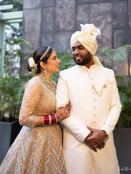 A close-up of the happy couple. You can see the details of her soft bridal makeup, with a focus on luminous skin and softly defined eyes.