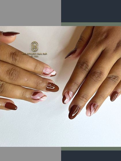 Inspired by a cup of coffee, this design features rich brown polish with creamy white swirls. It's a chic and sophisticated look that's perfect for autumn.