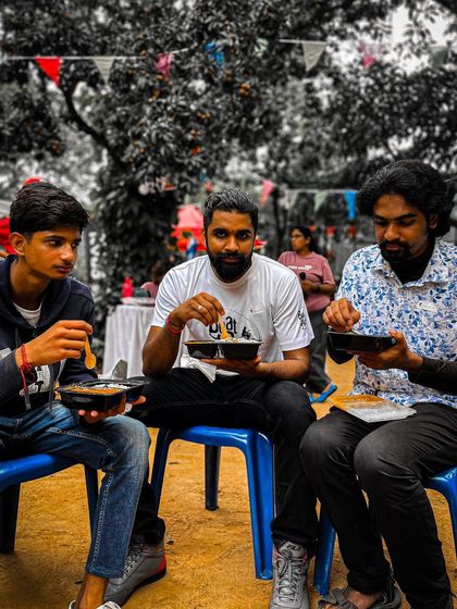 Friends enjoying a meal together at the Garage Sale. It's a perfect opportunity to refuel and socialize.