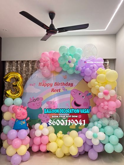 A pastel Peppa Pig theme for Reet's 3rd birthday. This decoration features a custom backdrop and a beautiful arch of pastel balloons with flower details.