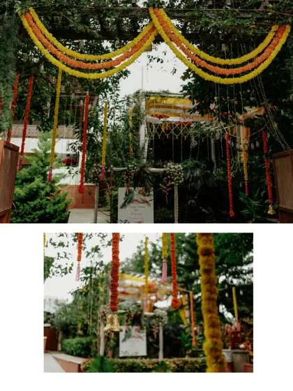 A closer look at the entrance decor, with hanging marigold strings and brass bells creating a festive and welcoming atmosphere.