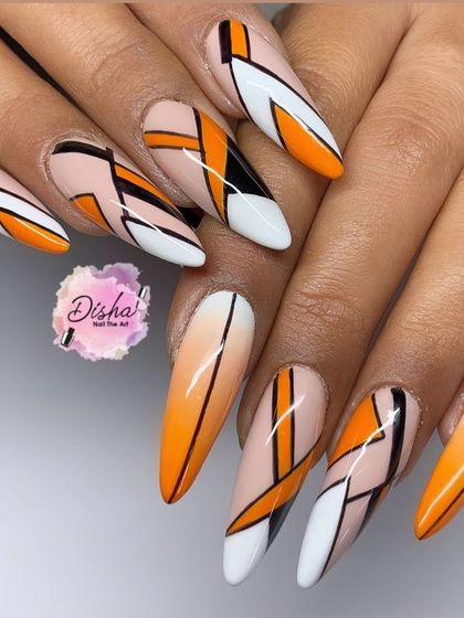A bold, graphic design with sharp lines and a vibrant orange gradient. This long, stiletto-shaped set is all about making a powerful statement.