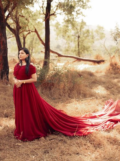 This off-shoulder red trail gown is one of my most requested pre-wedding outfits. Its long, flowing fabric creates beautiful movement in photos, perfect for a romantic shoot in nature.