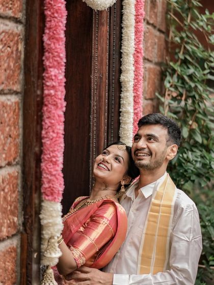 A happy moment between the bride and groom. The bride's makeup is natural and radiant, complementing her joyful smile.