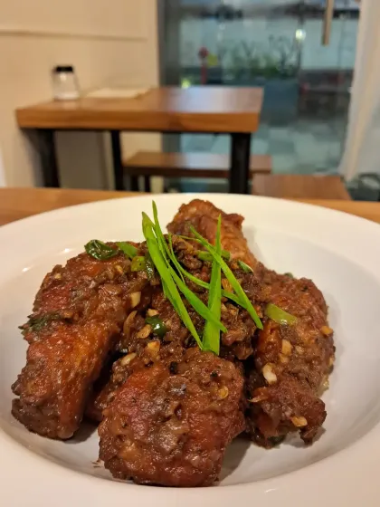 My famous Axone chicken wings. They have a strong, pungent, and deeply savory umami flavor from the fermented soybeans that is uniquely Naga. It’s a bold taste that might surprise you at first, but it’s one our regulars come back for again and again.