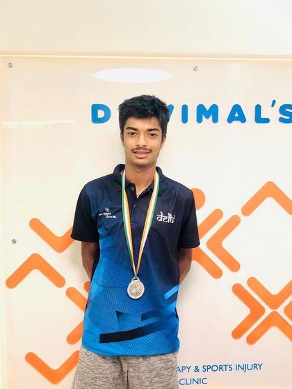 A solo shot of tennis player Ayush Sharma with his silver medal. We celebrate the hard work and dedication of all the athletes we work with.