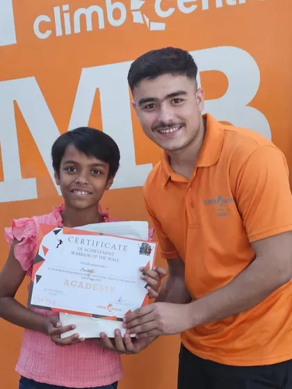 Celebrating a champion! A young winner receives her certificate at the 'Warrior of the Wall' event. It's all about recognizing effort and achievement.