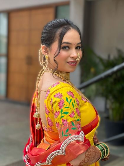 A beautiful back profile showcasing the custom-designed blouse and the elegant bridal bun, proving that every detail of the bridal look is important.