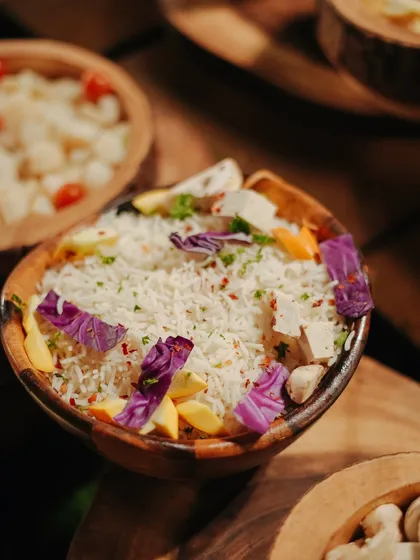A beautifully presented bowl of rice, garnished with edible flowers. We believe that even the simplest dishes should be served with artistry.