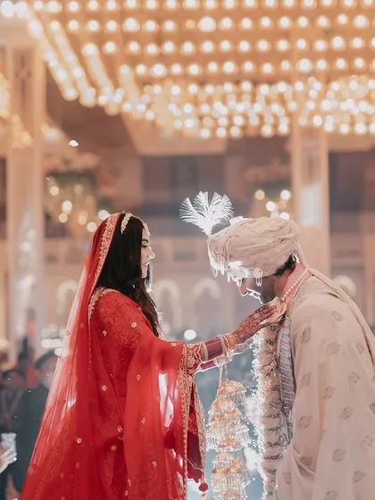 The Jaimala ceremony, a pivotal and joyous moment in an Indian wedding. We capture the expressions of the couple and the excitement of the crowd as garlands are exchanged.