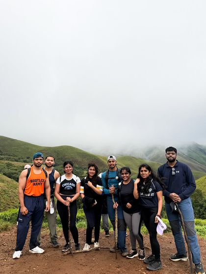 A small group of trekkers with their walking sticks, taking a quick break on the trail at Kudremukha.