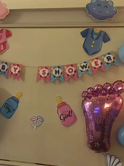 A close-up of the cute cutouts and banner for the baby shower theme.