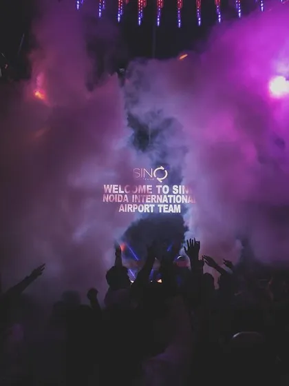 The crowd at SinQ, Goa, shrouded in purple smoke during a corporate event.