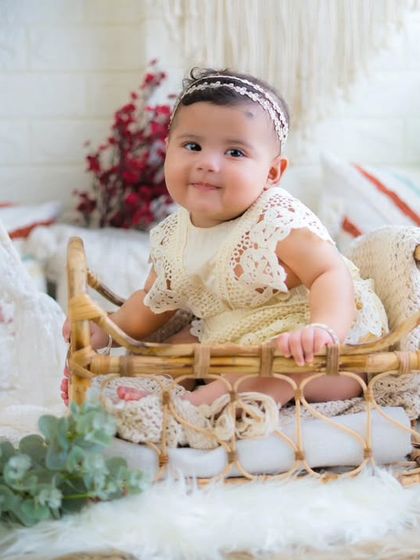 A sweet and curious baby girl in a rustic teepee setup. Milestone sessions are perfect for capturing their growing personalities.