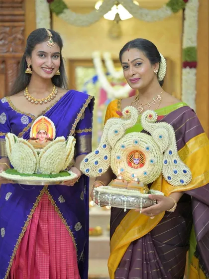 A portrait of elegance and tradition, as mother and daughter hold their offerings for the festival.