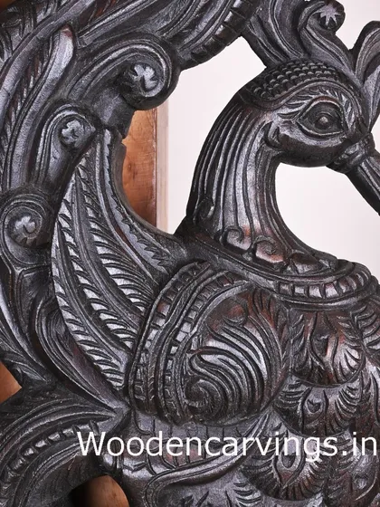 A detailed close-up of the head and neck of the dark brown Hamsa bracket, revealing the fine lines and textures of the carving.