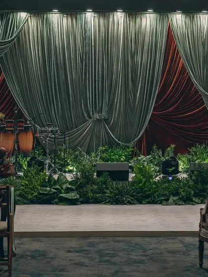 A stage set for a sangeet inspired by the dramatic artistry of Raja Ravi Varma. We used deep, contrasting velvets and lush foliage instead of extensive florals to create a moody, theatrical ambiance that feels like stepping into a timeless painting.