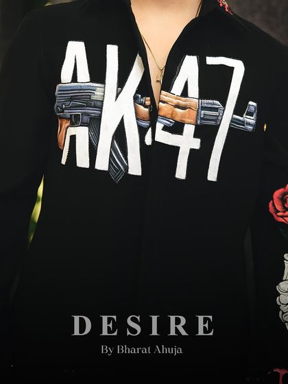 A macro shot of the hand-painted AK-47 graphic. The level of detail in the woodwork and metal makes this a true piece of wearable art.