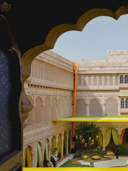 A view of the Haldi setup through an archway, showcasing the grand scale of the yellow drapes against the palace walls. This perspective highlights the dramatic and immersive environment we created.