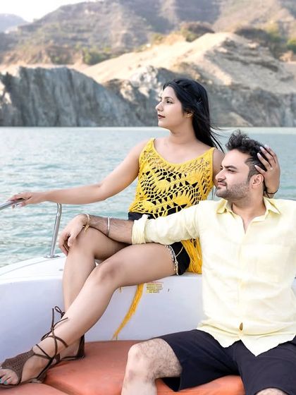 A tender moment between the couple on the boat. Her hand on his head shows care and affection, making for a very natural and sweet portrait.