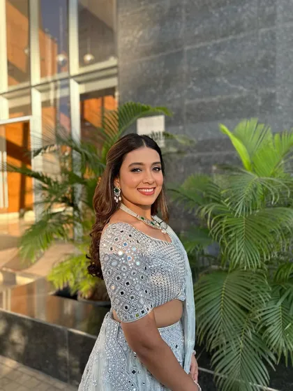 A beautiful, happy client enjoying her post-wedding glow with a simple and elegant hairstyle.
