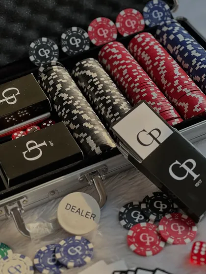 The full poker set, with rows of colorful, personalized chips and custom card decks, all housed in a professional aluminum case.