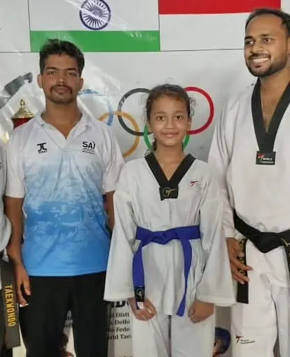 A student is promoted to blue belt, a significant step into the advanced levels of Taekwondo.