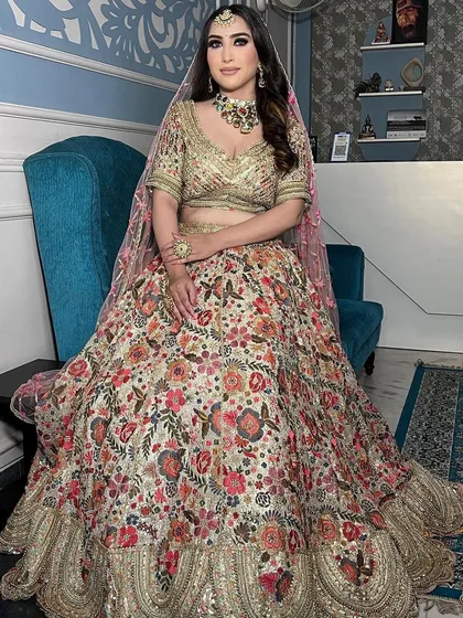 A gorgeous floral embroidered lehenga in a light, creamy base. This is a perfect example of a sophisticated and elegant choice for a day wedding or engagement.
