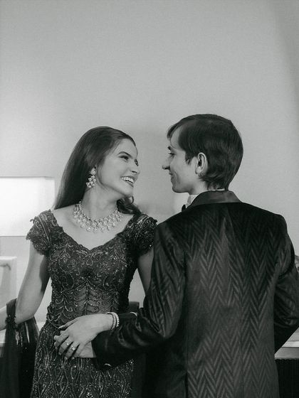A candid moment of joy. This black and white photo emphasizes the emotion and connection, with the bride's radiant makeup shining through.
