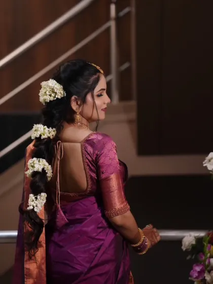 The back view shows a beautiful braided hairstyle adorned with fresh gajra, a classic choice for a traditional engagement.