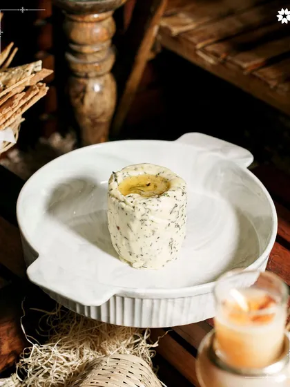 The simple art of a beautifully presented loaf and herb butter. It’s the foundational elements, done perfectly, that set the tone for a warm and inviting meal at home.