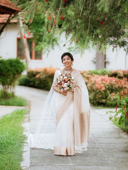 A joyful walking portrait of the bride in a beautiful garden, her smile radiant.