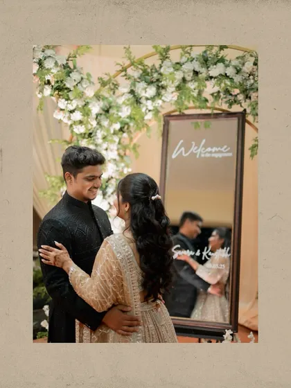 A creative engagement portrait using a mirror to reflect the couple's embrace. This adds a unique and artistic touch to their photo collection.