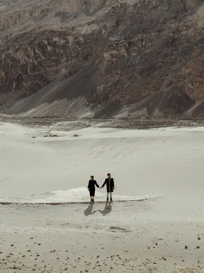 For the couple whose love is an adventure. Here in the vast, breathtaking landscapes of Ladakh, I captured the couple against the epic scale of the mountains, showing that their journey together is the greatest adventure of all.