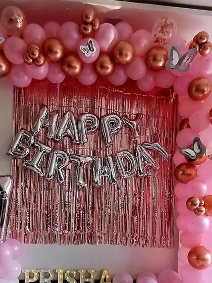 A beautiful pink and rose gold butterfly theme for Prisha's 7th birthday. I designed a full balloon arch over a metallic pink fringe curtain, with silver "Happy Birthday" foil letters and a matching number '7' balloon.