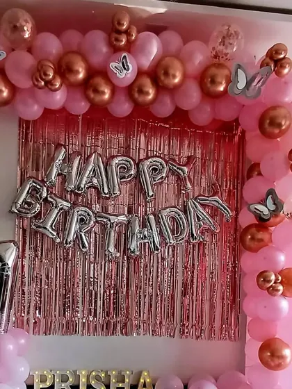 A beautiful pink and rose gold butterfly theme for Prisha's 7th birthday. I designed a full balloon arch over a metallic pink fringe curtain, with silver "Happy Birthday" foil letters and a matching number '7' balloon.