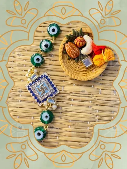 A modern and protective rakhi featuring the auspicious swastika symbol surrounded by evil eye beads. It’s a beautiful blend of tradition and trend.