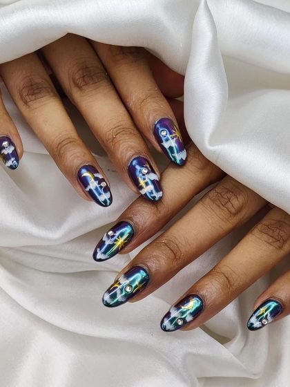 A full view of the magical night sky nail art, showing the beautiful color-shifting effect and detailed embellishments.