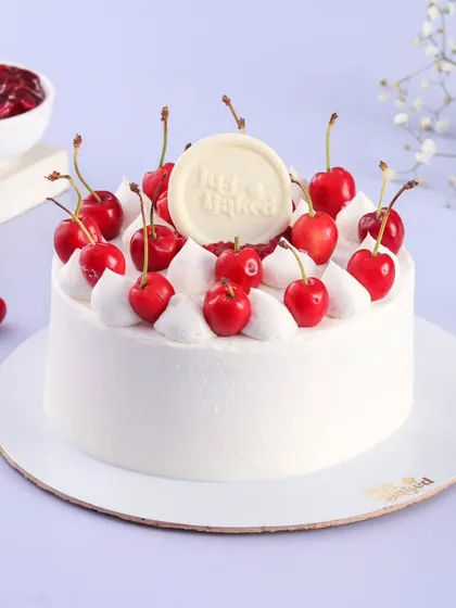 My fresh cherry cake is a perfect treat for the rainy season. This one features a light vanilla sponge, fresh cream, and is topped with bright, juicy cherries.