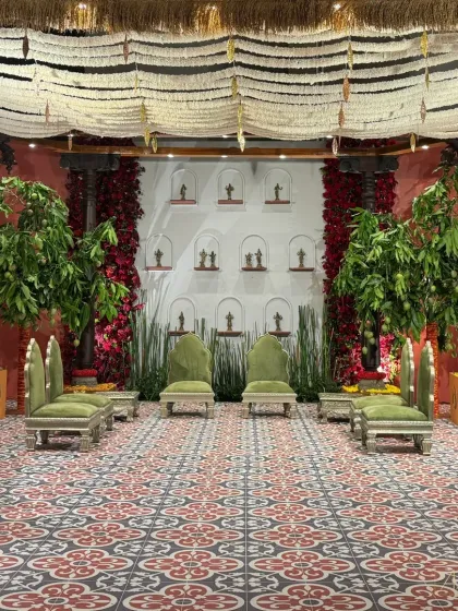 Welcome to 'Divya Stambh', a majestic celebration that transports you to a South Indian temple sanctuary. The design features sculpted stone pillars, rich brass accents, and lotus motifs, creating a deconstructed yet divine experience.