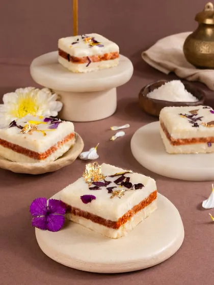 Delicate layered cakes with edible flowers and gold leaf. The bright, airy styling on white marble makes them look light, precious, and utterly beautiful.