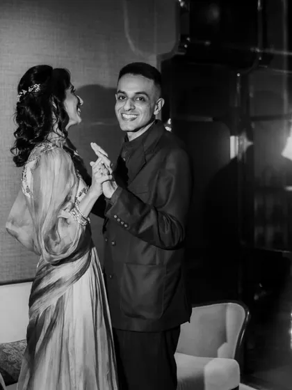 A happy, candid moment on the dance floor captured in black and white. This photo freezes a moment of genuine connection and fun between the couple.