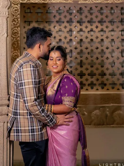 A tender moment captured. The bride looks serene and beautiful in her lavender silk saree, with her makeup kept soft and radiant to let her natural happiness shine through.