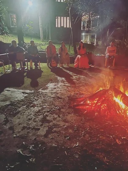 Our community gathered around a bonfire at night. These moments of shared ritual and chanting under the stars create a deep sense of spiritual connection and friendship.