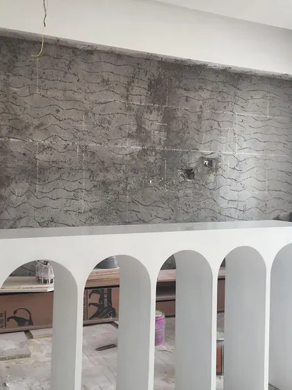 The arched console for the Vishu Home during the construction phase. This behind-the-scenes photo shows the piece being built and prepared for its final coat of vibrant red paint.